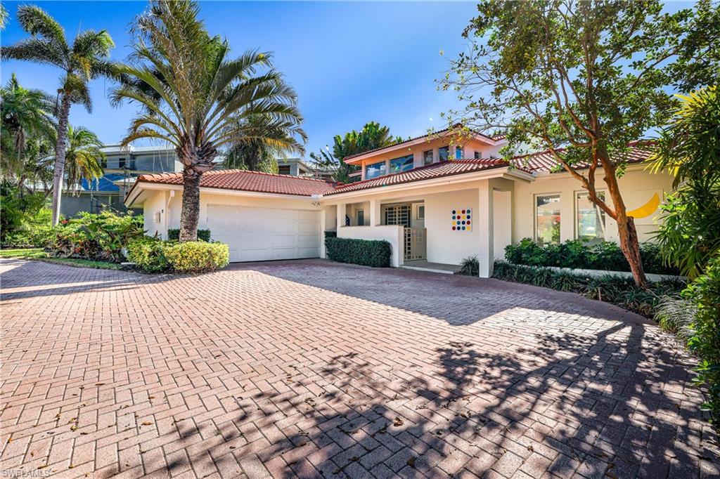 536 Turtle Hatch Road Naples, FL 34103 - Photo 1 of 28 Mediterranean / spanish home featuring stucco siding, decorative driveway, a tile roof, and an attached garage