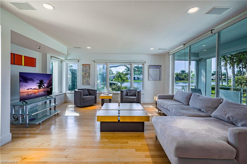 536 Turtle Hatch Road Naples, FL 34103 - Photo 12 of 28 Living area featuring light wood finished floors, healthy amount of natural light, a water view, and recessed lighting