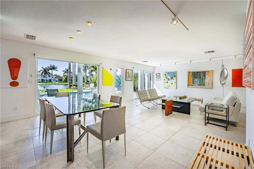 536 Turtle Hatch Road Naples, FL 34103 - Photo 13 of 28 Dining space featuring track lighting, a water view, light tile patterned floors, and french doors