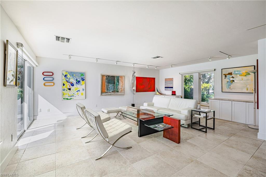 536 Turtle Hatch Road Naples, FL 34103 - Photo 15 of 28 Living area with track lighting, plenty of natural light, and light tile patterned floors