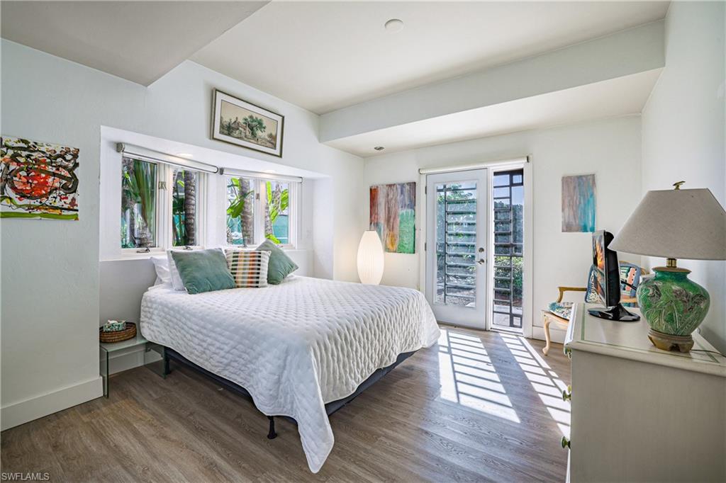 536 Turtle Hatch Road Naples, FL 34103 - Photo 21 of 28 Bedroom featuring french doors, wood finished floors, multiple windows, and access to outside