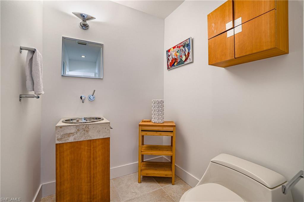 536 Turtle Hatch Road Naples, FL 34103 - Photo 24 of 28 Bathroom featuring vanity and light tile patterned floors