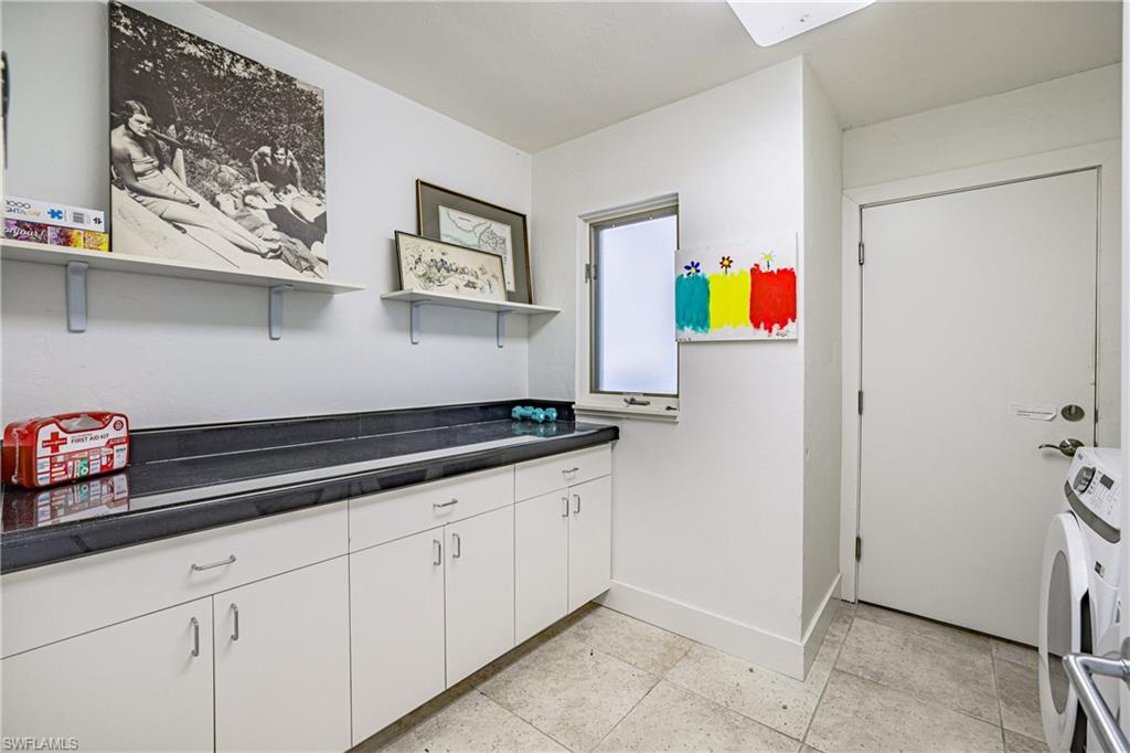 536 Turtle Hatch Road Naples, FL 34103 - Photo 25 of 28 Laundry area with cabinet space and washing machine and dryer