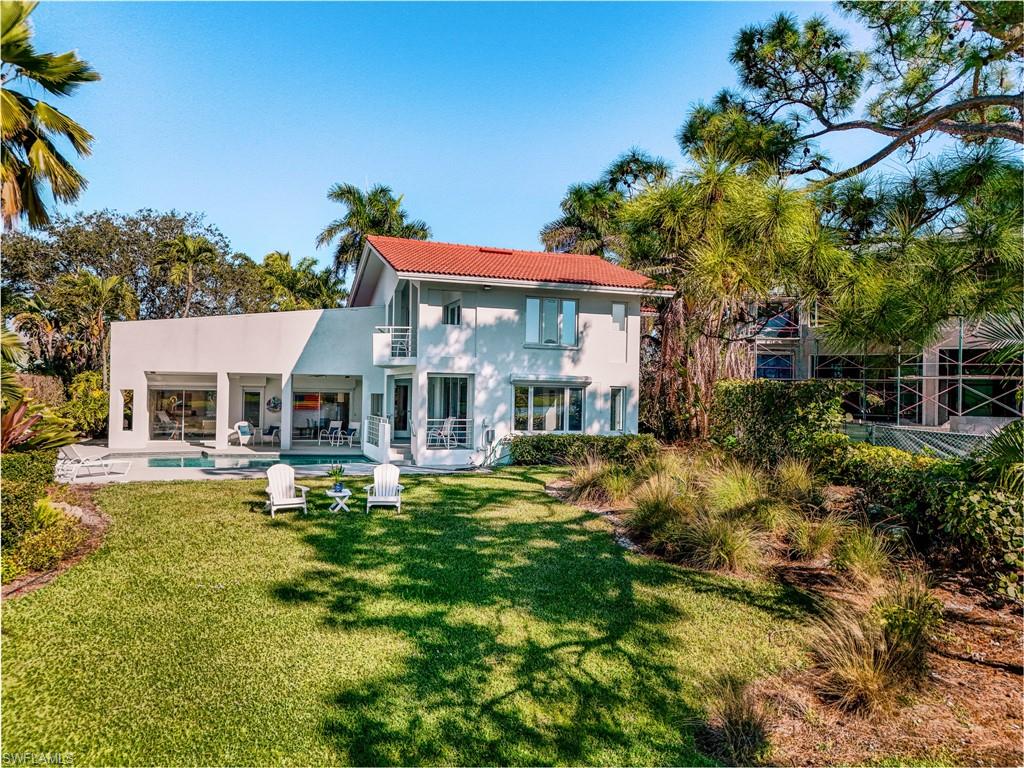 536 Turtle Hatch Road Naples, FL 34103 - Photo 6 of 28 Back of house featuring an outdoor pool, a patio, stucco siding, a yard, and a tiled roof