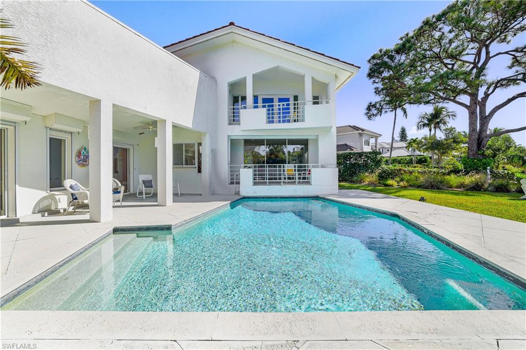 536 Turtle Hatch Road Naples, FL 34103 - Photo 7 of 28 Rear view of house featuring an outdoor pool, stucco siding, a balcony, a patio, and ceiling fan