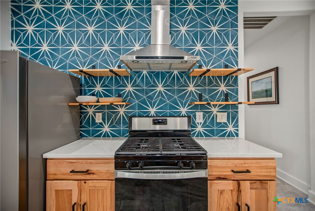 804 Tyler Avenue Port O'Connor, TX 77982 - Photo 14 of 43 a stove top oven sitting inside of a kitchen