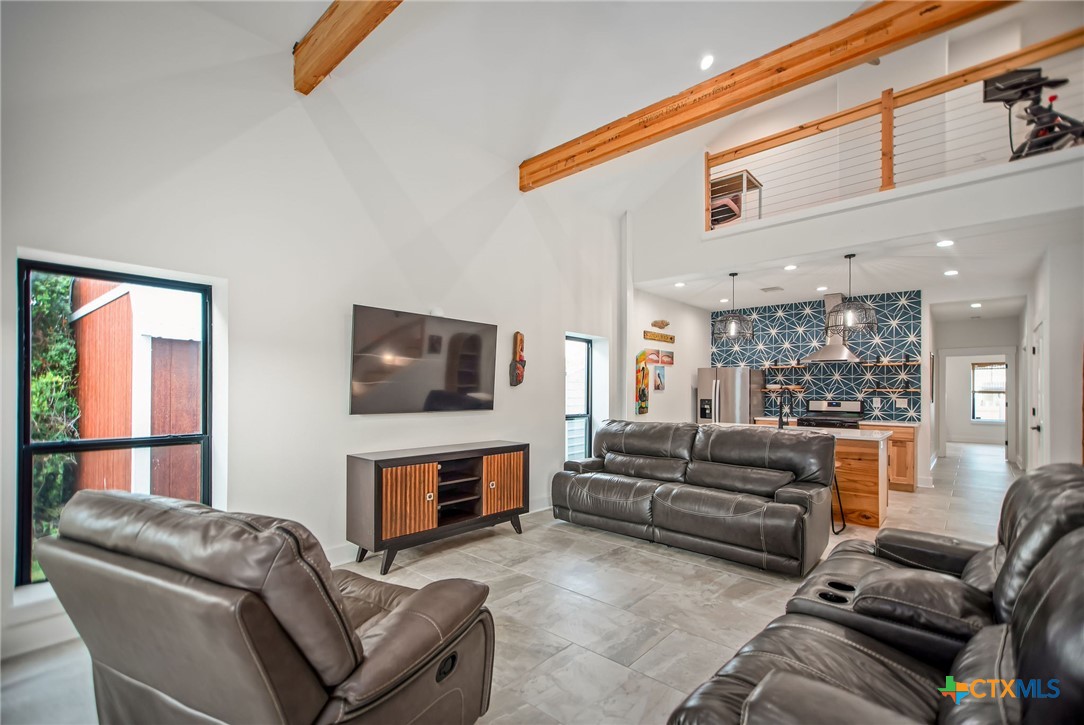 804 Tyler Avenue Port O'Connor, TX 77982 - Photo 18 of 43 a living room with furniture a flat screen tv and a fireplace