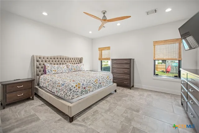 a bedroom with a bed and a flat screen tv