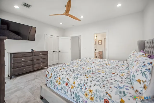 a bedroom with a bed and flat screen tv