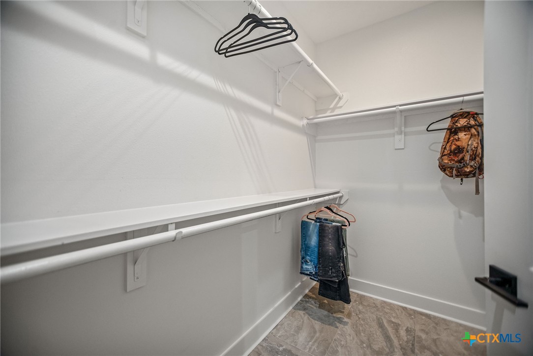 804 Tyler Avenue Port O'Connor, TX 77982 - Photo 28 of 43 a view of walk in closet with clothes and shoes