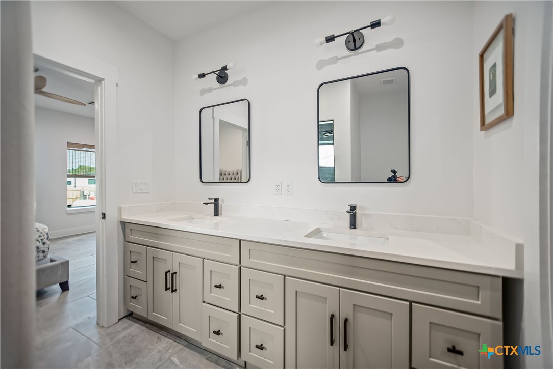 804 Tyler Avenue Port O'Connor, TX 77982 - Photo 29 of 43 a bathroom with double vanity sink two mirror and a