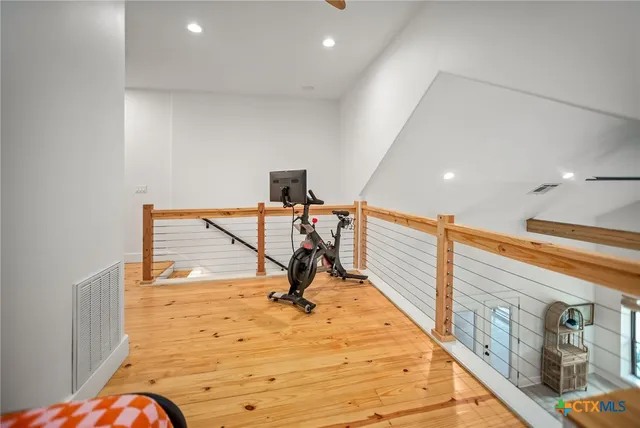 a view of a hall with wooden floor