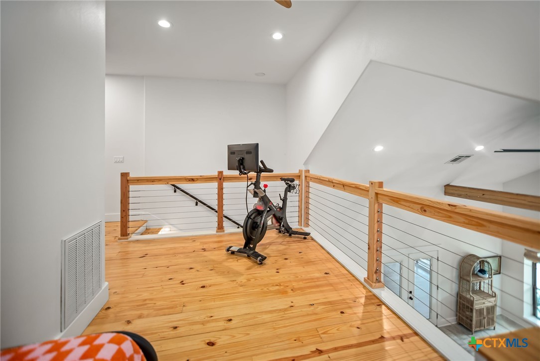 804 Tyler Avenue Port O'Connor, TX 77982 - Photo 32 of 43 a view of a hall with wooden floor