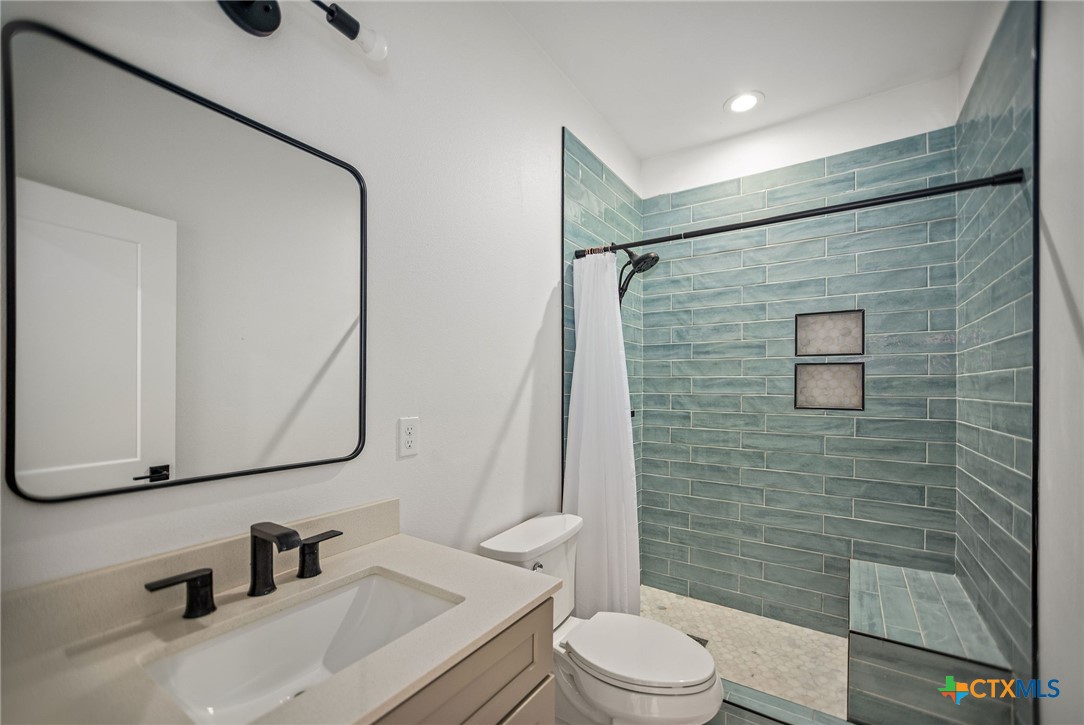 804 Tyler Avenue Port O'Connor, TX 77982 - Photo 38 of 43 a bathroom with a sink a toilet and shower