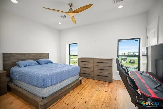 a bedroom with a bed and flat screen tv