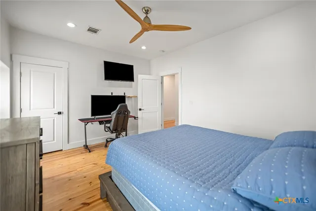 a bedroom with a bed and a flat screen tv