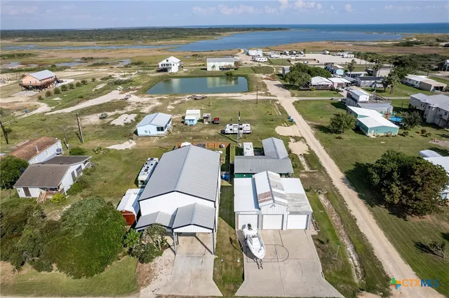 an aerial view of residential houses with outdoor space