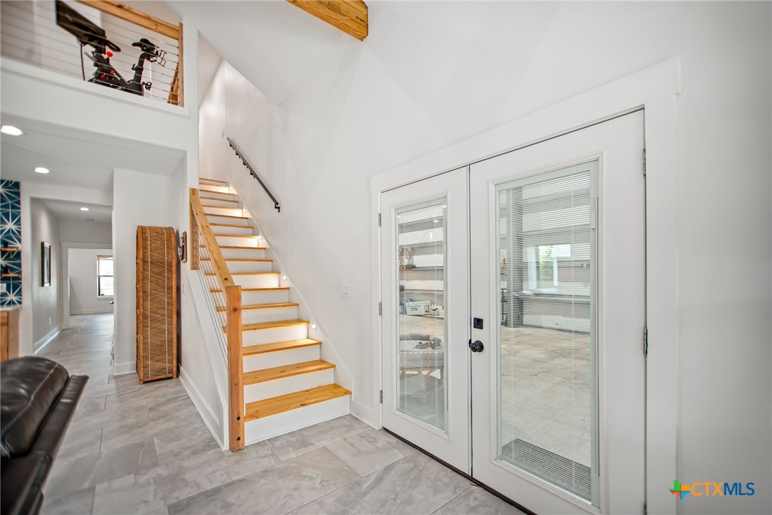 804 Tyler Avenue Port O'Connor, TX 77982 - Photo 9 of 43 a view of a hallway with staircase and white walls