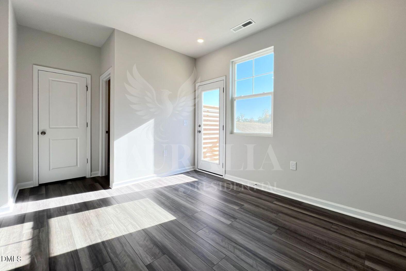 181 Ivy Vine Way Raleigh, NC 27610 - Photo 5 of 22 a view of an empty room with wooden floor and a window