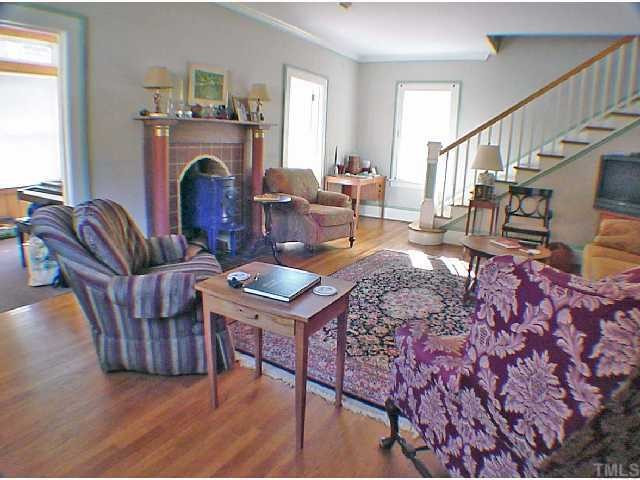 2605 Vanderbilt Avenue Raleigh, NC 27607 - Photo 2 of 10 Living room is spacious, light and bright, and features a fireplace with wood burning stove. Living Room