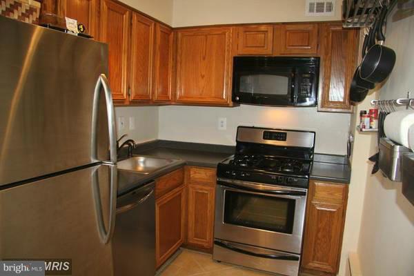 430 M Street Southwest, Unit N810 Washington, DC 20024 - Photo 2 of 18 a kitchen with stainless steel appliances granite countertop a stove microwave and refrigerator