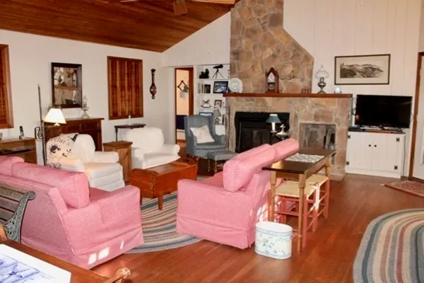 a living room with furniture a flat screen tv and a fireplace