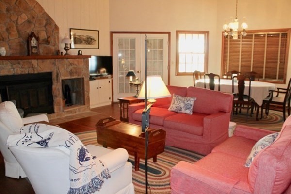 71 Bartimus Luce Road West Tisbury, MA 02568 - Photo 4 of 8 a living room with furniture kitchen view and a fireplace