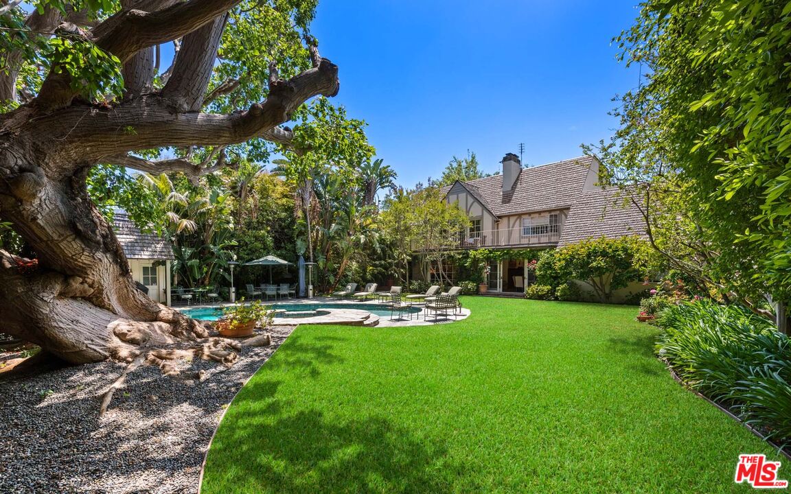 620 North Crescent Drive Beverly Hills, CA 90210 - Photo 12 of 23 a view of a swimming pool with a yard and plants