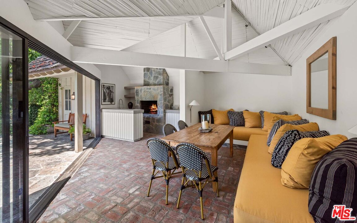620 North Crescent Drive Beverly Hills, CA 90210 - Photo 14 of 23 a living room with furniture and a floor to ceiling window