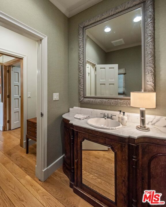 620 North Crescent Drive Beverly Hills, CA 90210 - Photo 17 of 23 a bathroom with a sink and a mirror