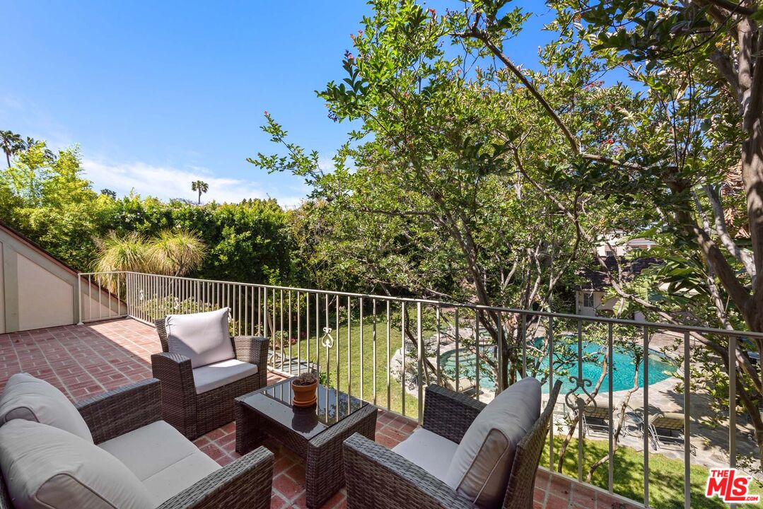 620 North Crescent Drive Beverly Hills, CA 90210 - Photo 19 of 23 a balcony with wooden floor and outdoor seating