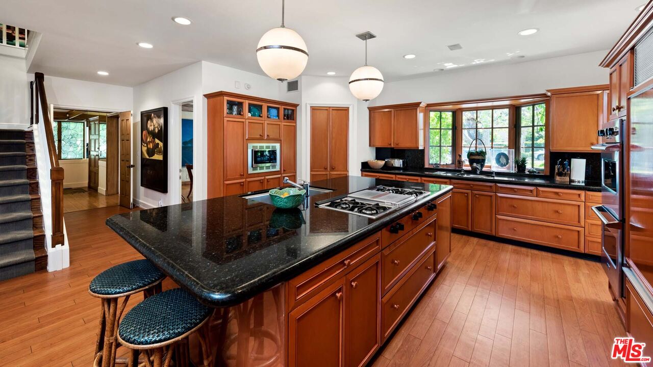620 North Crescent Drive Beverly Hills, CA 90210 - Photo 7 of 23 a kitchen with stainless steel appliances granite countertop a stove a sink and a refrigerator