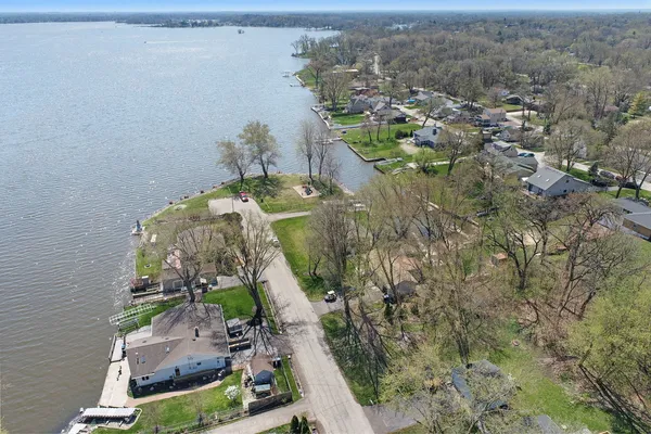 an aerial view of a house with a yard