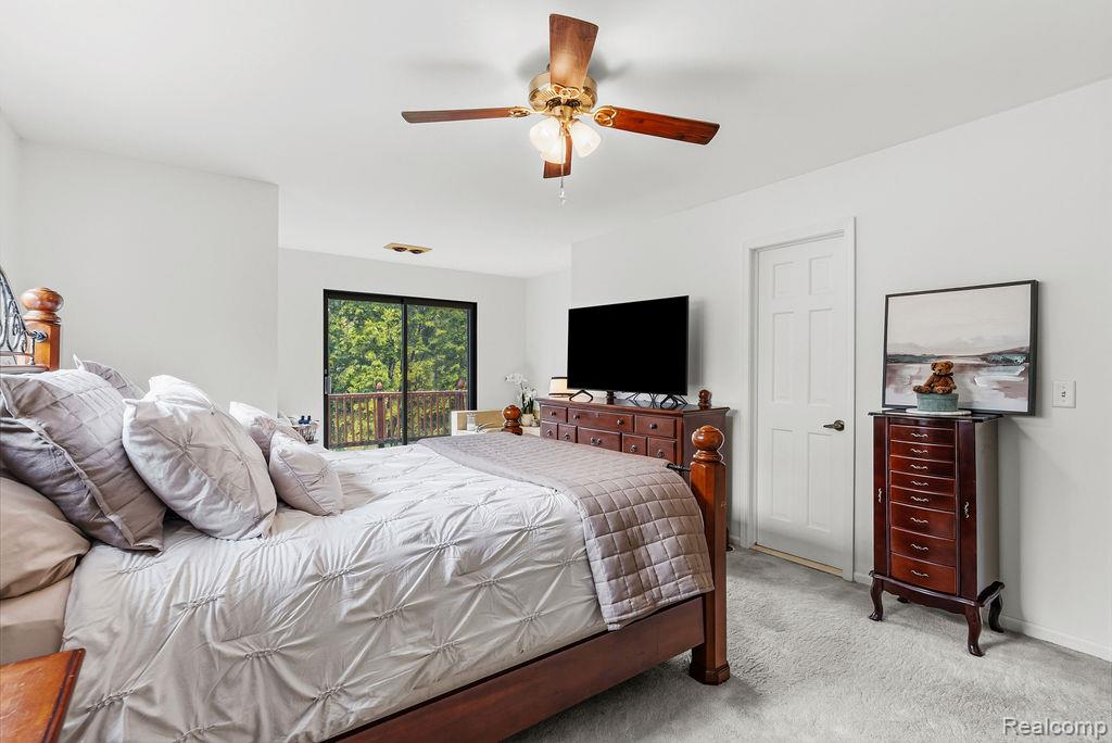 11111 Hibner Road Hartland, MI 48353 - Photo 31 of 59 Carpeted bedroom with access to outside and ceiling fan