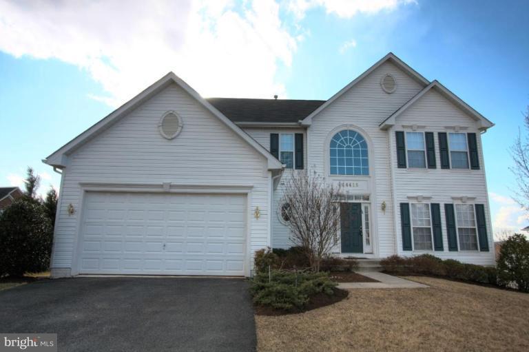 14418 Autumn Crest Road Boyds, MD 20841 - Photo 1 of 26 a front view of a house with a yard and garage