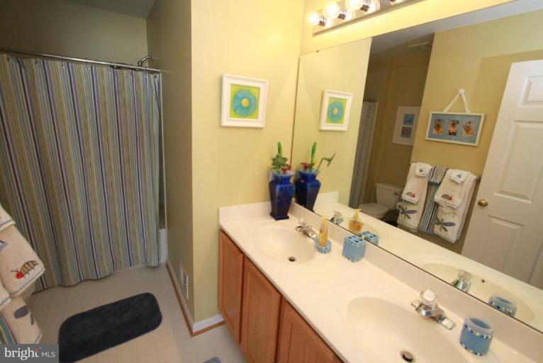 14418 Autumn Crest Road Boyds, MD 20841 - Photo 13 of 26 a bathroom with a sink vanity and mirror