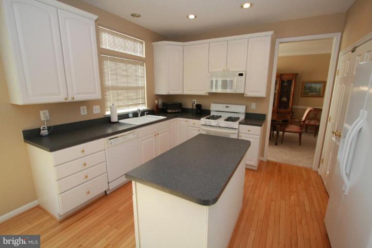 14418 Autumn Crest Road Boyds, MD 20841 - Photo 14 of 26 a kitchen with granite countertop a sink a counter top space stainless steel appliances and cabinets