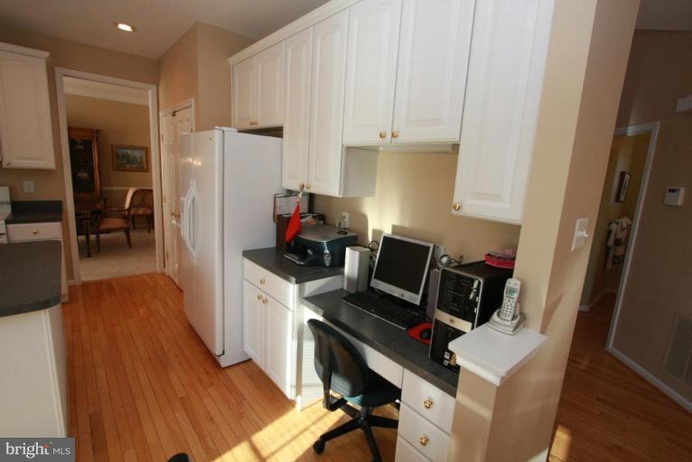 14418 Autumn Crest Road Boyds, MD 20841 - Photo 15 of 26 a kitchen with a refrigerator and a stove top open