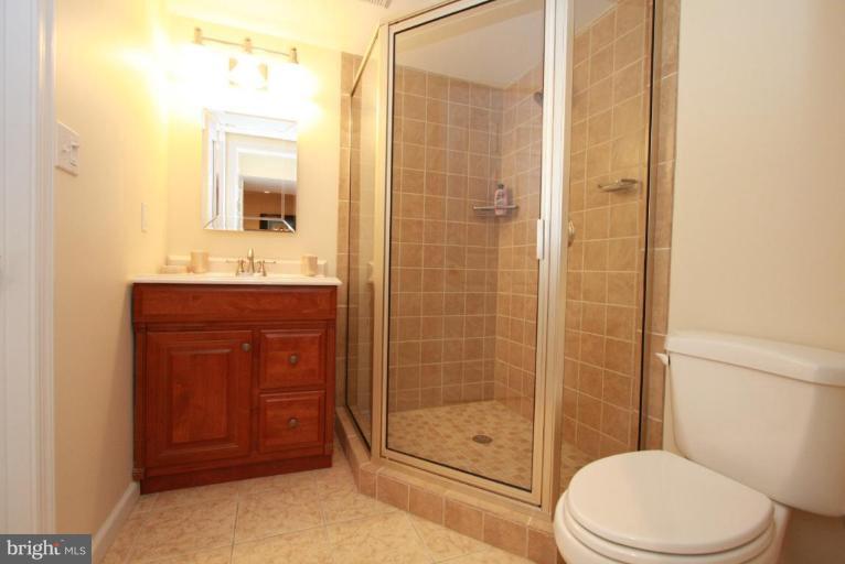 14418 Autumn Crest Road Boyds, MD 20841 - Photo 18 of 26 a bathroom with a toilet a sink and shower