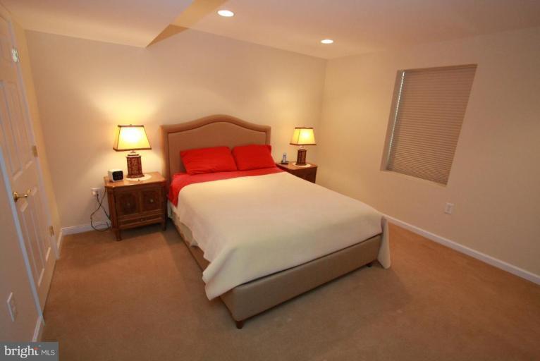 14418 Autumn Crest Road Boyds, MD 20841 - Photo 19 of 26 a bedroom with a bed and a night stand