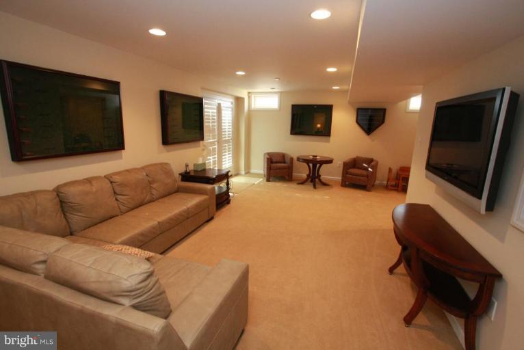 14418 Autumn Crest Road Boyds, MD 20841 - Photo 20 of 26 a living room with furniture and a flat screen tv