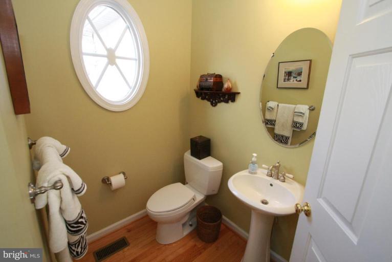 14418 Autumn Crest Road Boyds, MD 20841 - Photo 24 of 26 a bathroom with a toilet sink and mirror