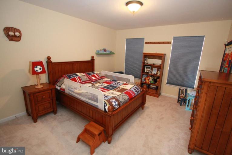 14418 Autumn Crest Road Boyds, MD 20841 - Photo 4 of 26 a bedroom with a bed and wooden floor