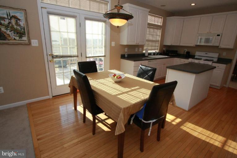 14418 Autumn Crest Road Boyds, MD 20841 - Photo 8 of 26 a kitchen with a table chairs sink and cabinets