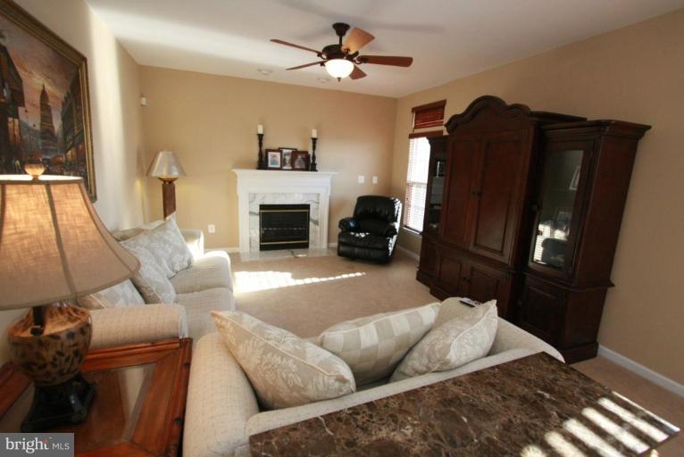 14418 Autumn Crest Road Boyds, MD 20841 - Photo 9 of 26 a living room with furniture and a fireplace