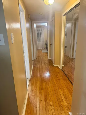 a view of a hallway with wooden floor