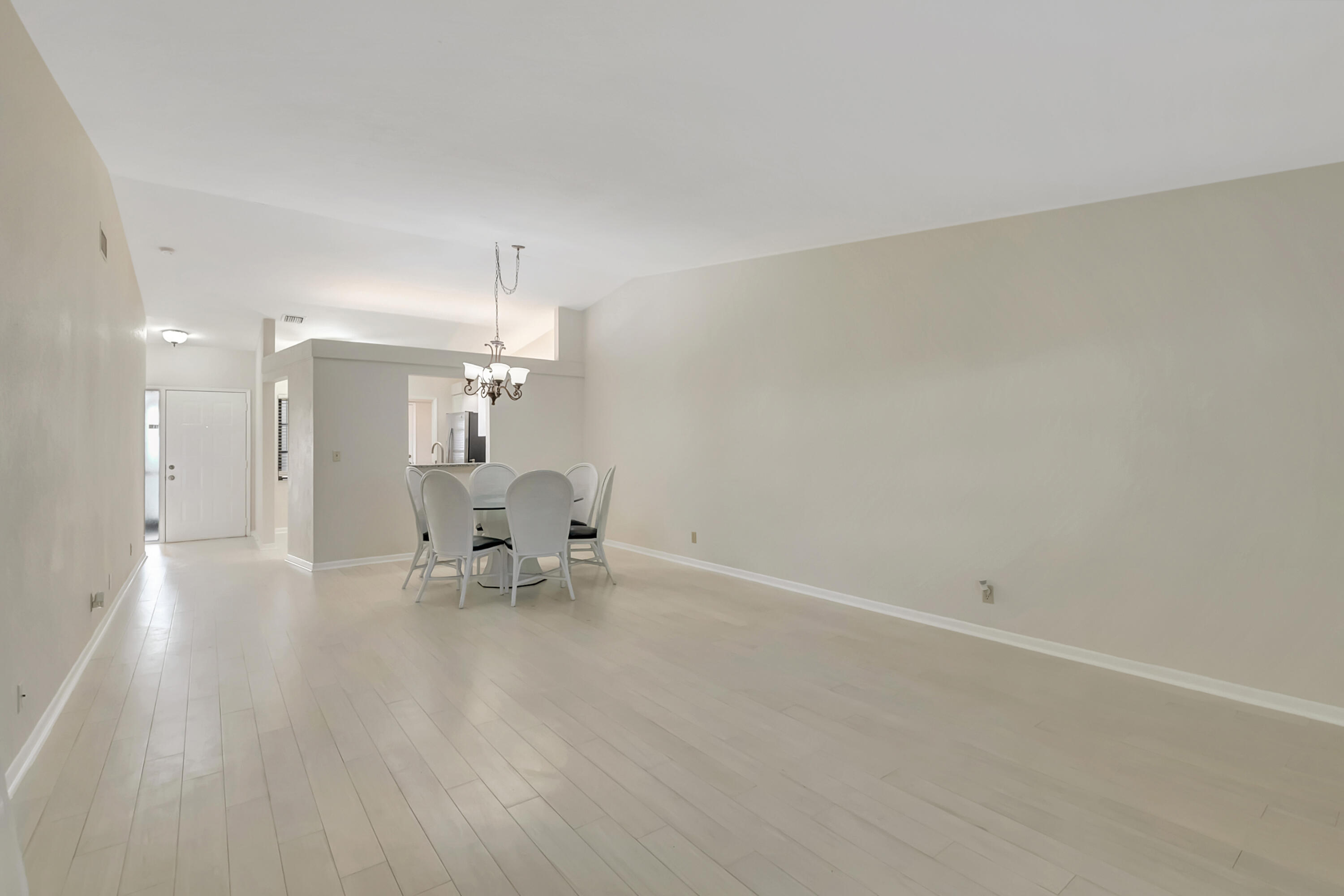 18559 Breezy Palm Way Boca Raton, FL 33496 - Photo 11 of 43 a view of an empty room with a dining table and a chandelier