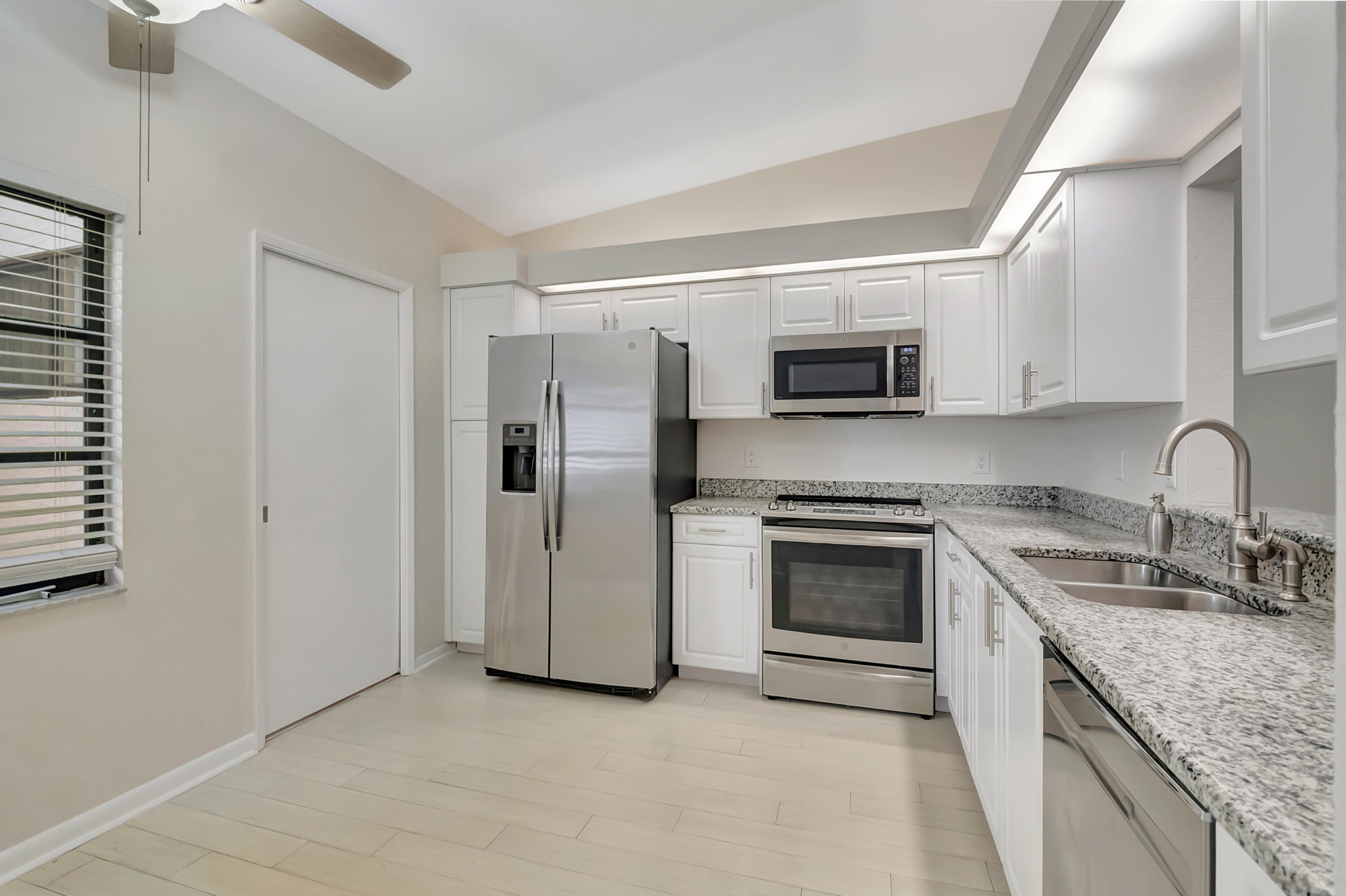 18559 Breezy Palm Way Boca Raton, FL 33496 - Photo 14 of 43 a kitchen with stainless steel appliances granite countertop a stove top oven a sink and dishwasher