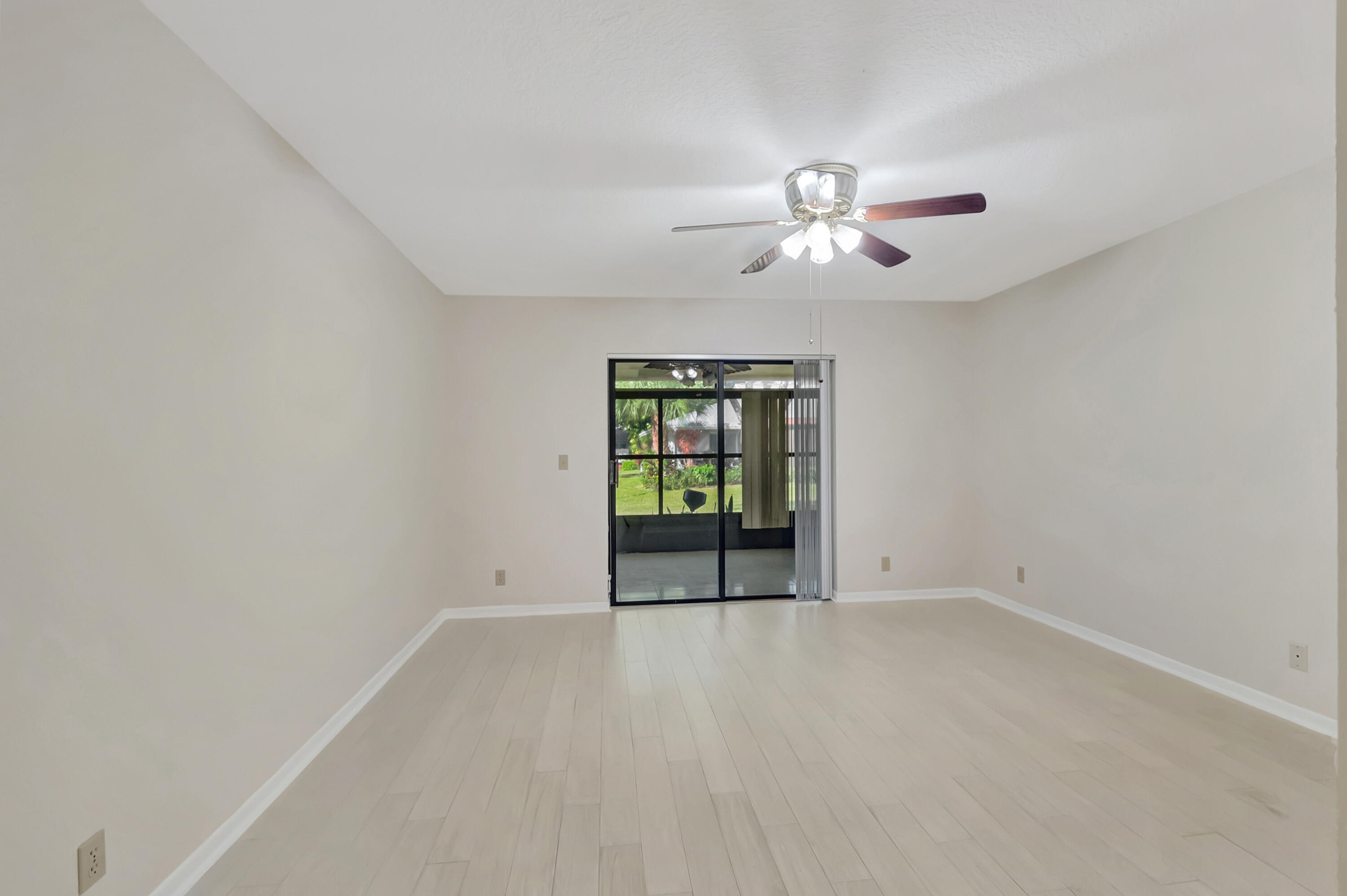 18559 Breezy Palm Way Boca Raton, FL 33496 - Photo 20 of 43 an empty room with chandelier fan and windows