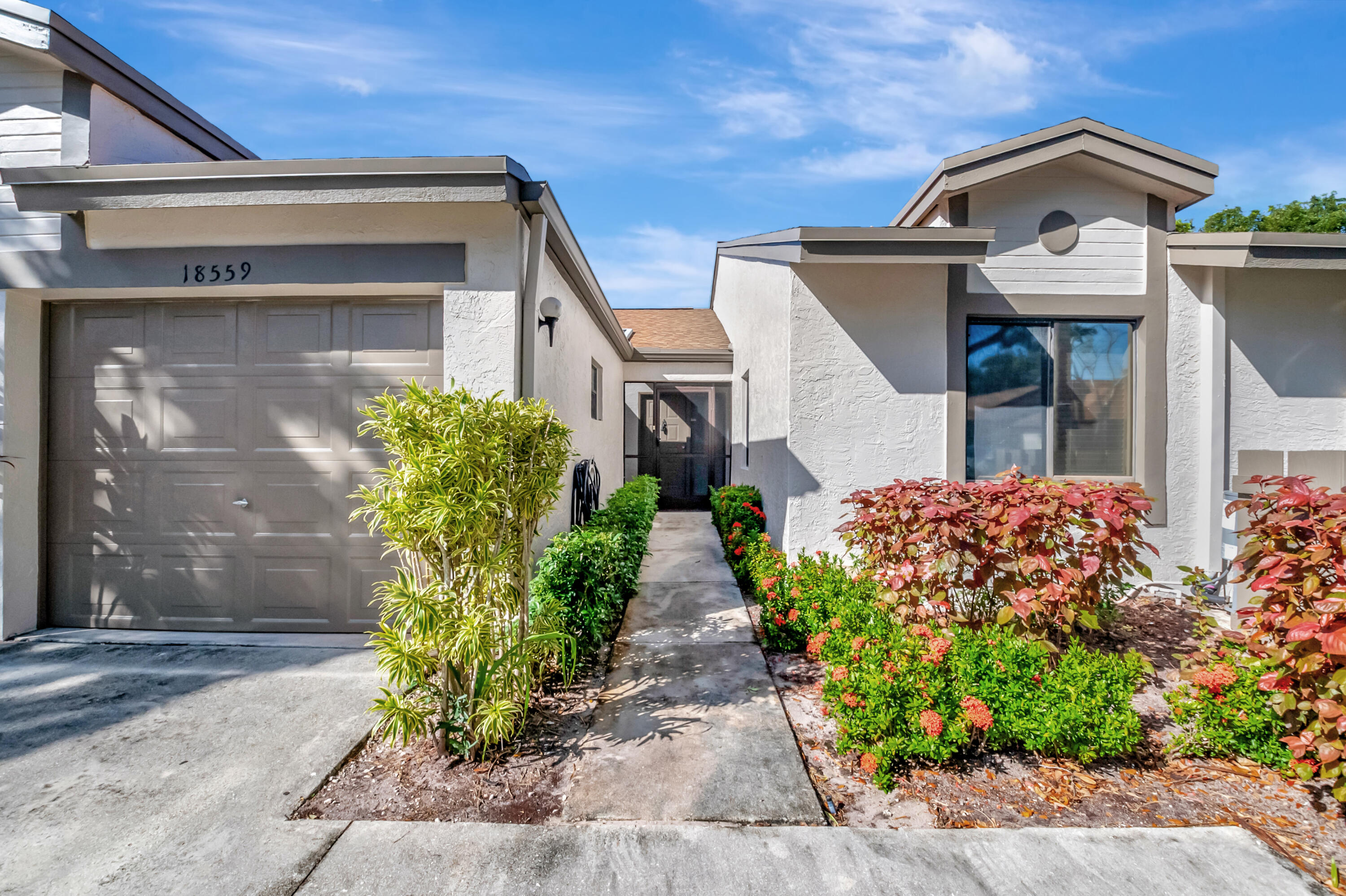 18559 Breezy Palm Way Boca Raton, FL 33496 - Photo 2 of 43 a front view of a house with garden